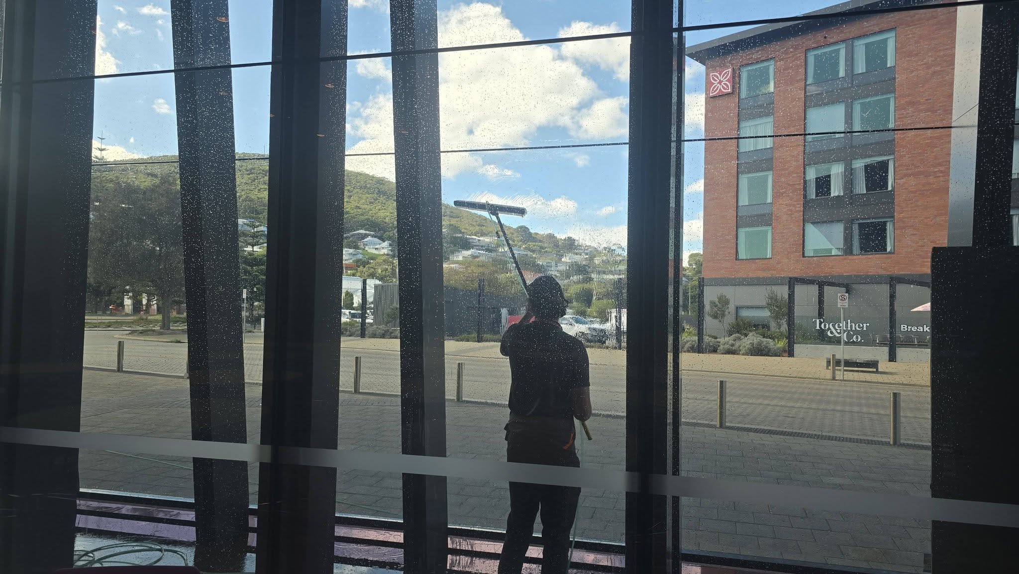 Cleaning the windows of a commercial building in Albany